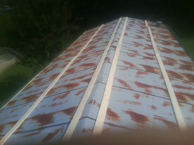 Rusted metal roof panels with new wood purlins before replacement — Storm Damage Roof Repair in Skippack by Roofing Brothers